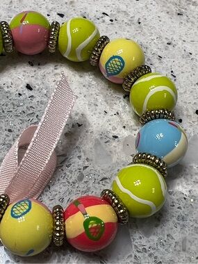 Angela Moore tennis rackets tennis balls bracelet